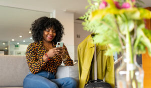 Woman on her mobile device in a hotel lobby.